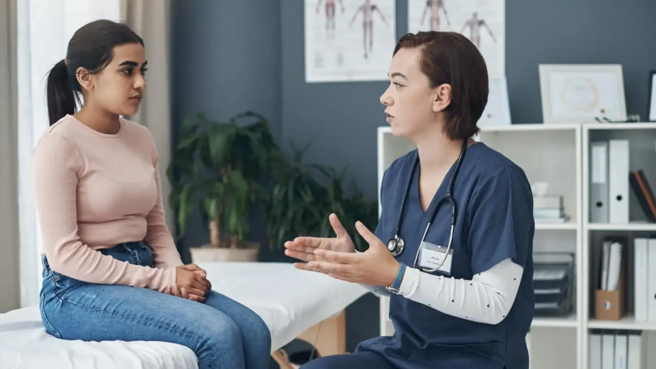 Doctor discussing Fintepla treatment and cardiac monitoring requirements with a young patient during a clinical consultation