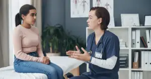 Doctor discussing Fintepla treatment and cardiac monitoring requirements with a young patient during a clinical consultation