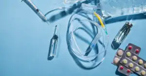 Ancillary supplies for clinical trials including a syringe, infusion set, IV bag, ampoule, vial and blister packs