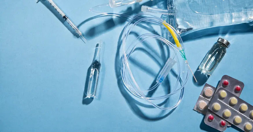 Ancillary supplies for clinical trials including a syringe, infusion set, IV bag, ampoule, vial and blister packs