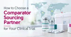 Comparator drug vials for clinical trial use beside a 2–8°C cold chain shipper and a world map of global sourcing routes